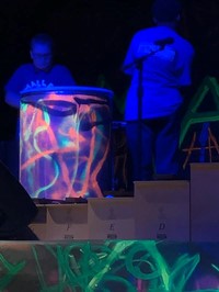 a student playing a big drum