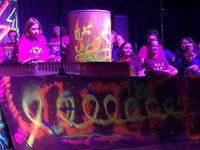students smiling near xylophones on stage