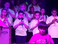 students playing flute on stage